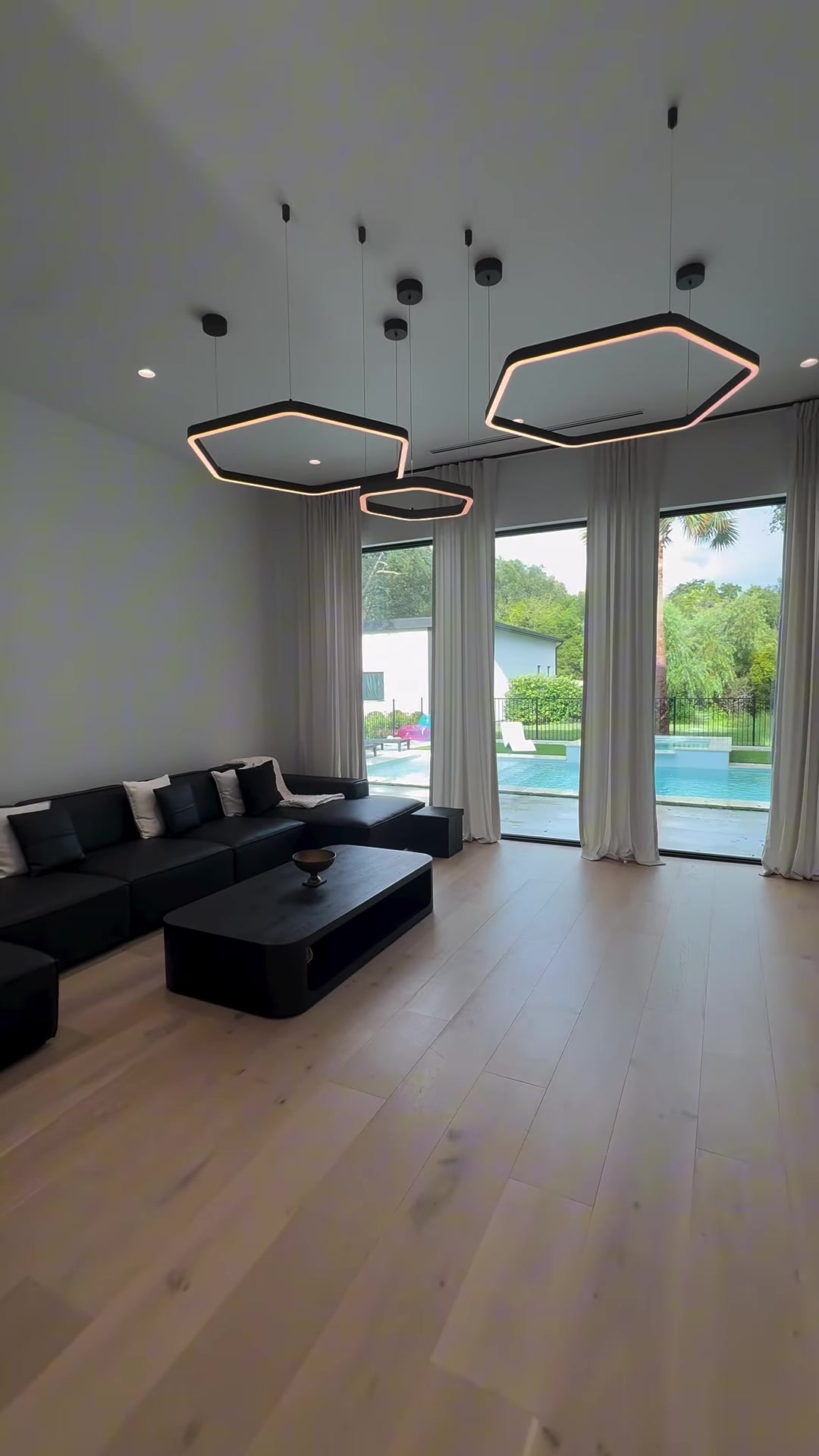 Completed light-filled living space with sculptural ceiling fixtures